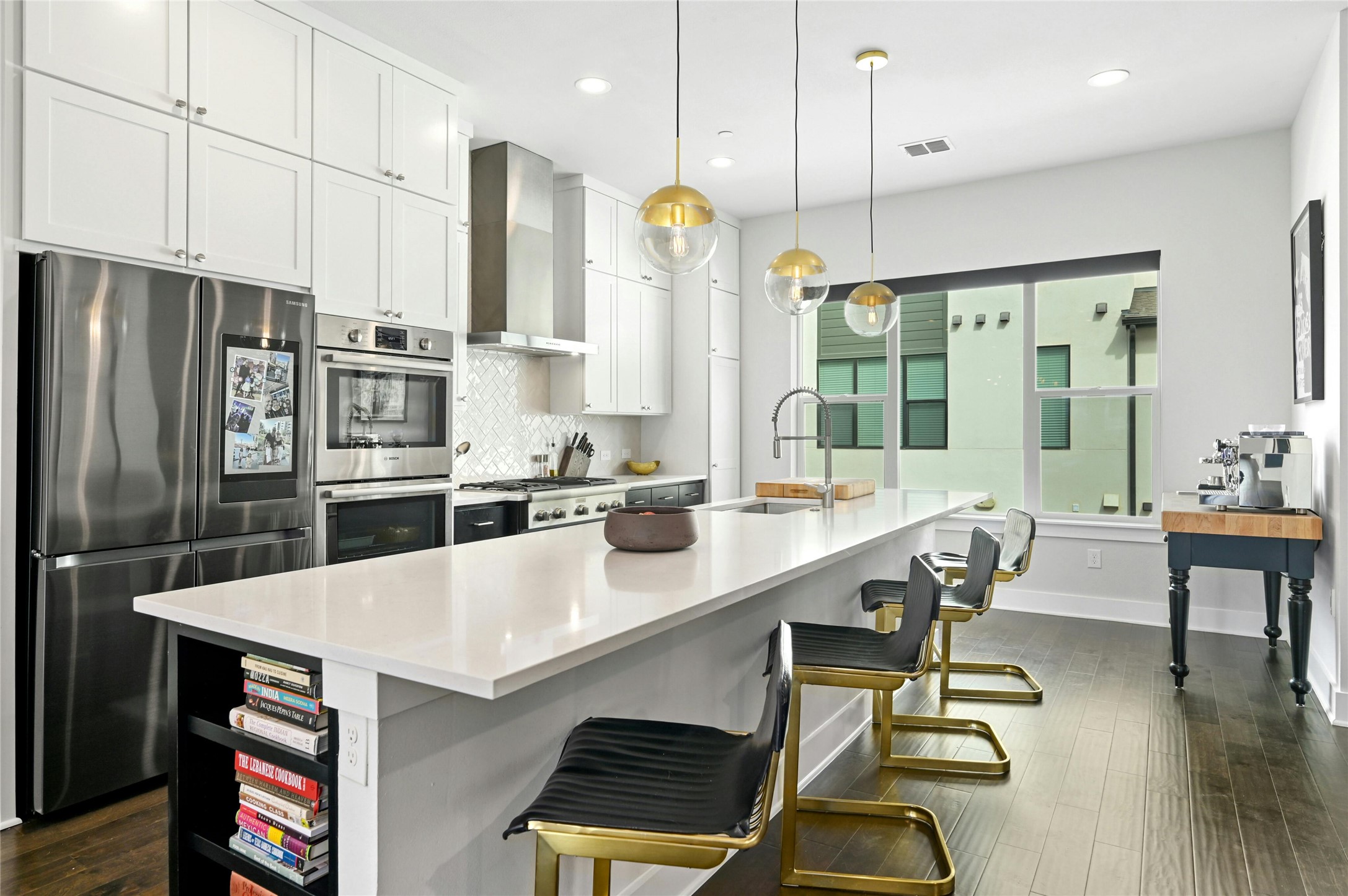 4604 Longevity Drive, Unit 306 Austin, TX 78731 - Photo 14 of 34 a large kitchen with kitchen island a large window a sink and stainless steel appliances