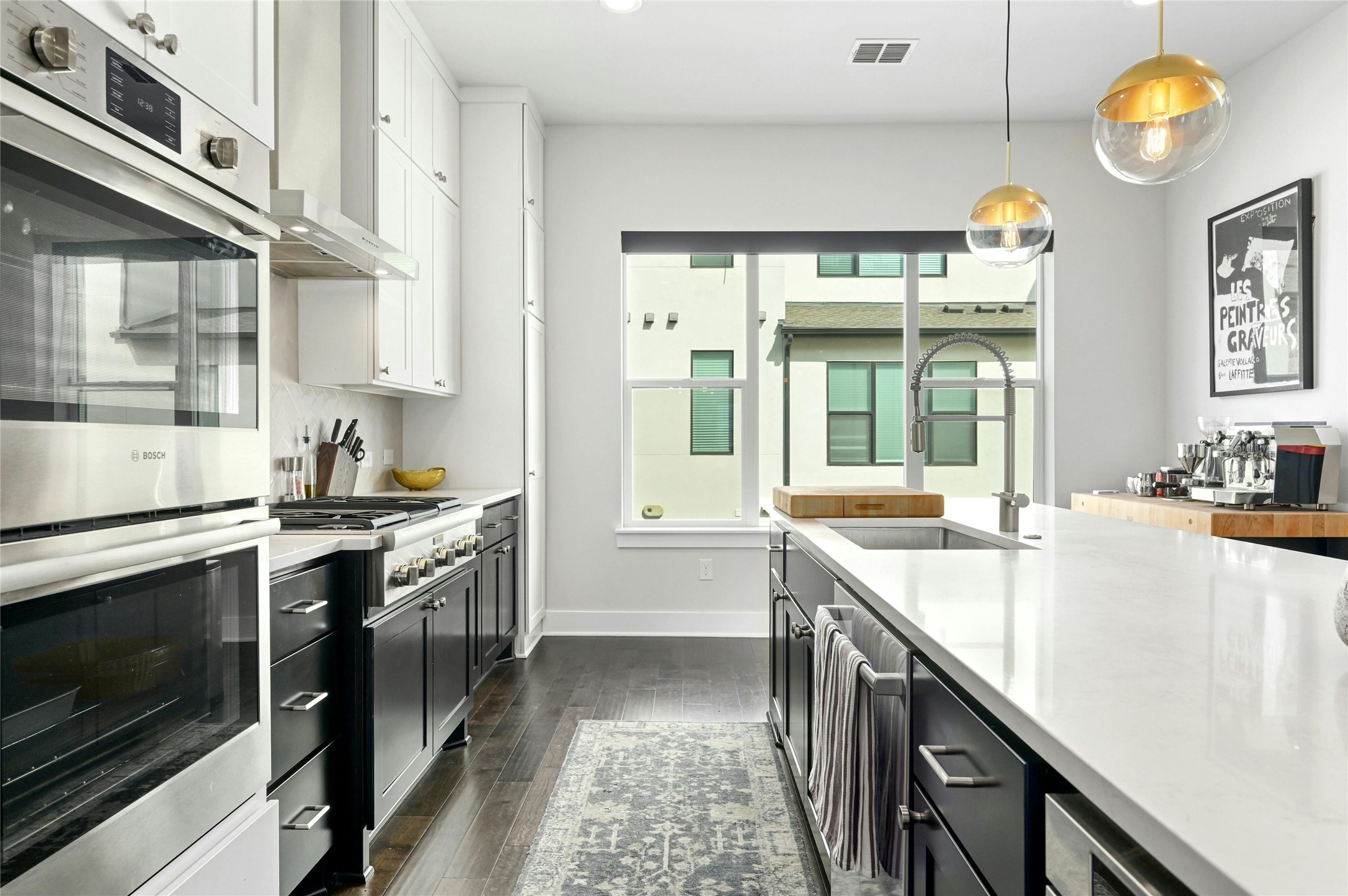 4604 Longevity Drive, Unit 306 Austin, TX 78731 - Photo 15 of 34 a large kitchen with stainless steel appliances granite countertop a stove a sink and a refrigerator