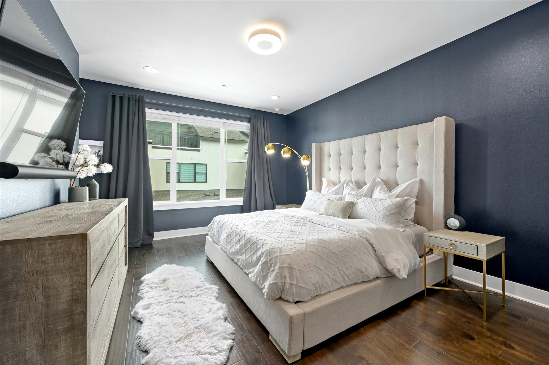 4604 Longevity Drive, Unit 306 Austin, TX 78731 - Photo 17 of 34 a bedroom with a large bed and a large window