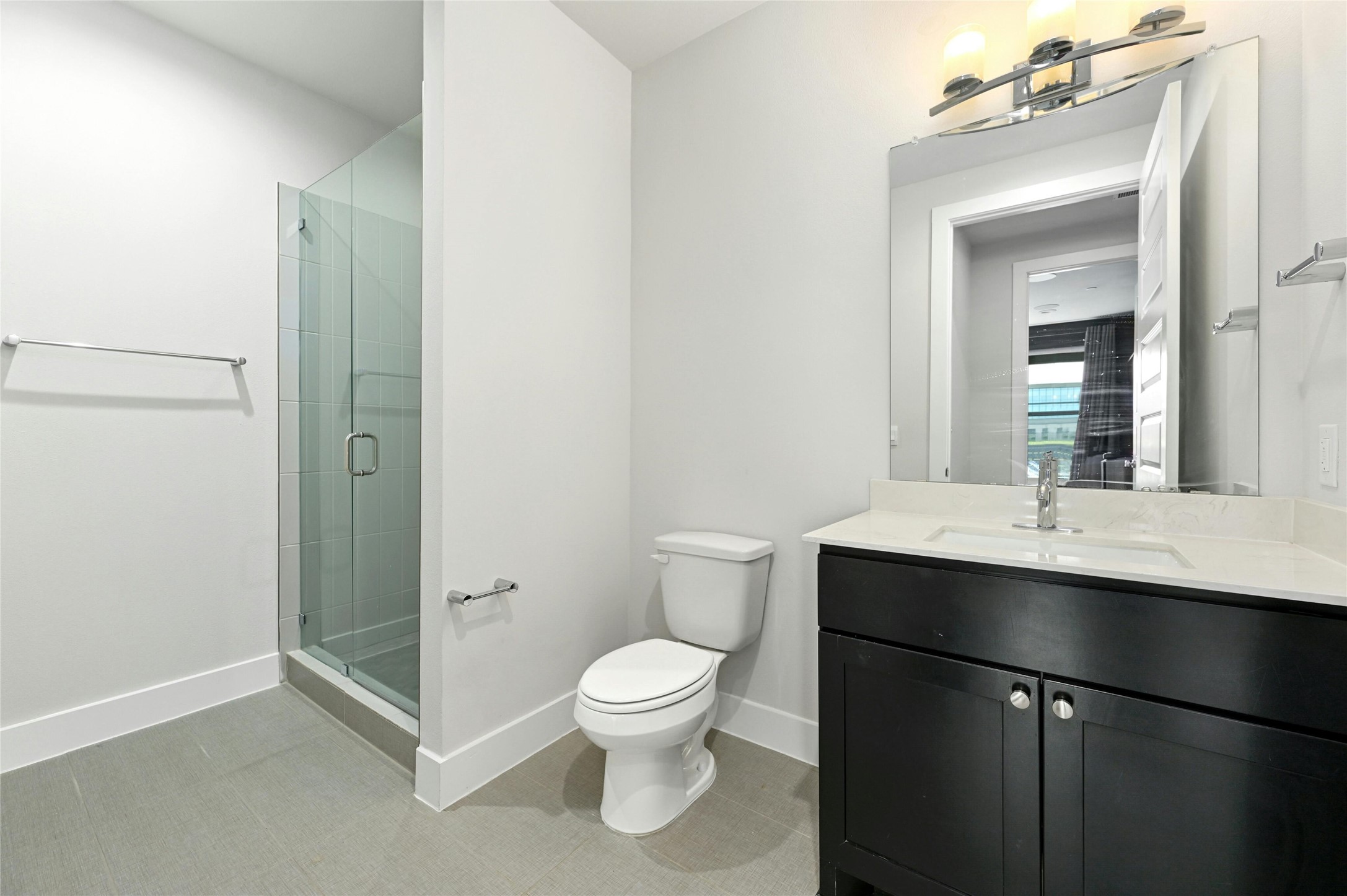 4604 Longevity Drive, Unit 306 Austin, TX 78731 - Photo 7 of 34 a bathroom with a toilet a sink and mirror