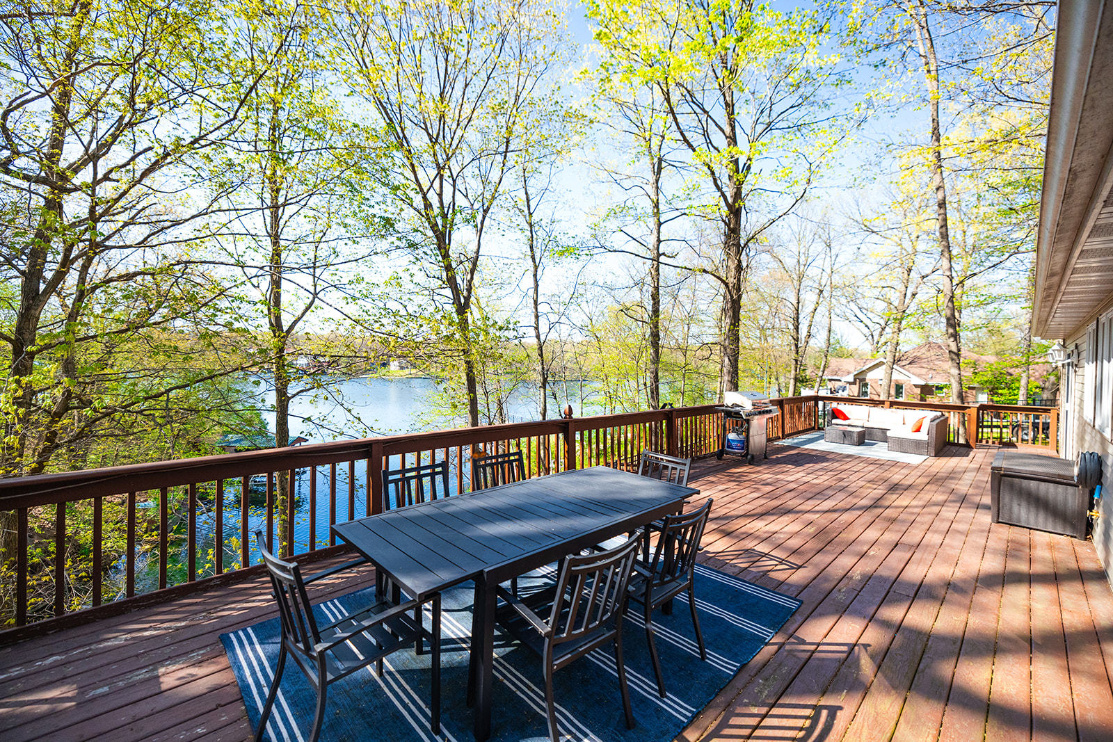 147 Lake Thunderbird Drive Putnam, IL 61560 - Photo 9 of 50 a view of a patio with table and chairs and couches with wooden floor and fence