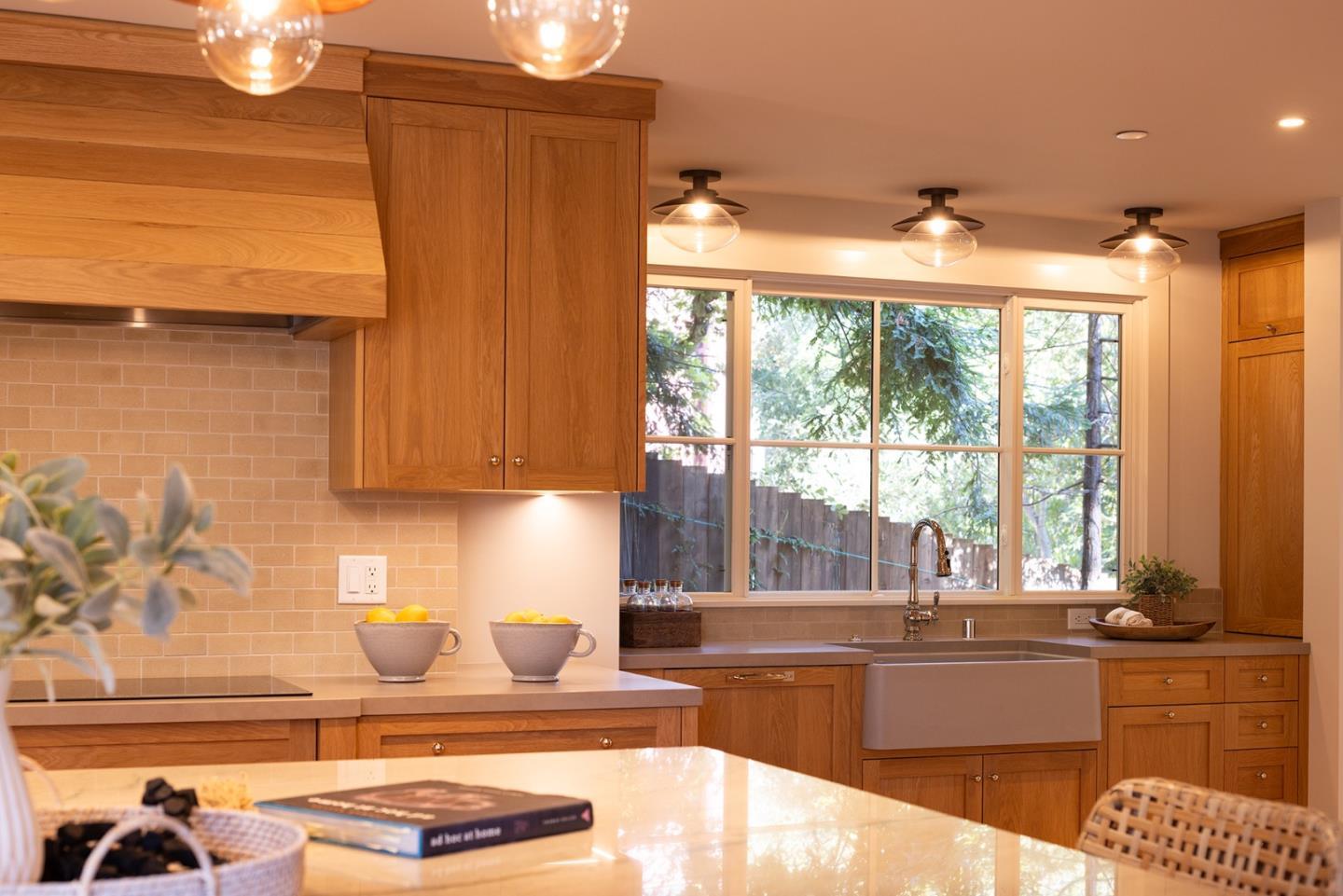 4 Oak Knoll Way Carmel, CA 93923 - Photo 19 of 49 a kitchen with granite countertop a stove and a white sink