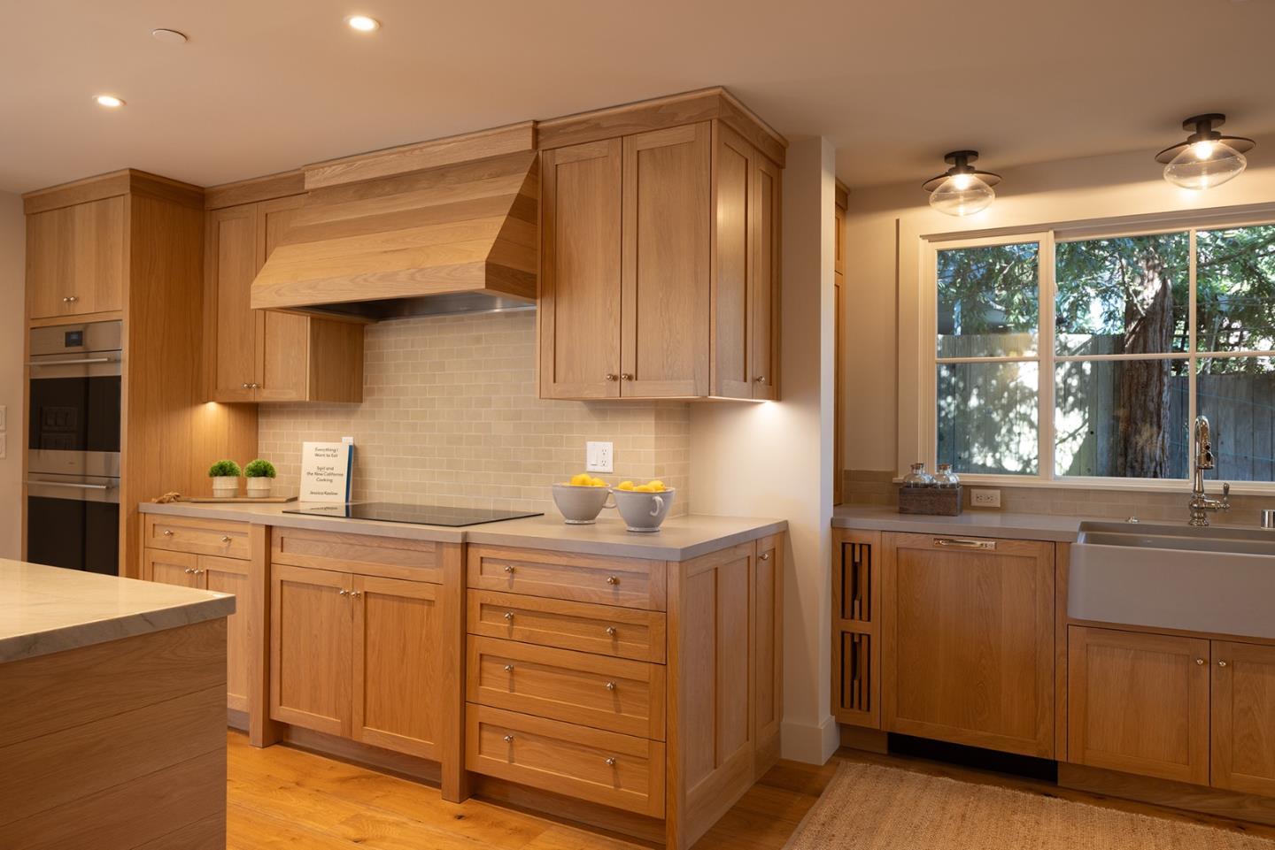 4 Oak Knoll Way Carmel, CA 93923 - Photo 22 of 49 a kitchen with kitchen island granite countertop a sink and wooden cabinets