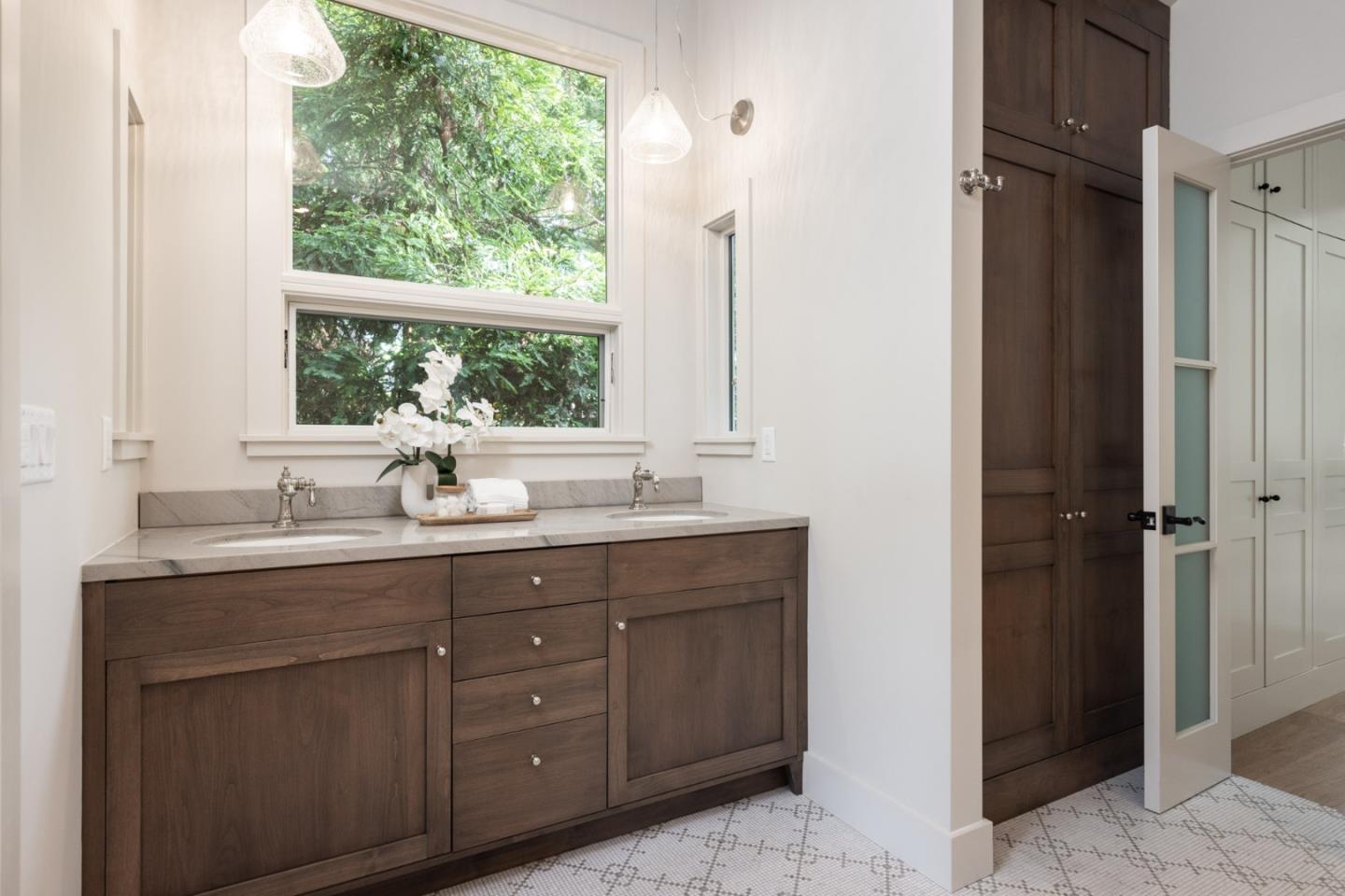 4 Oak Knoll Way Carmel, CA 93923 - Photo 35 of 49 a bathroom with a double vanity sink a mirror and a window
