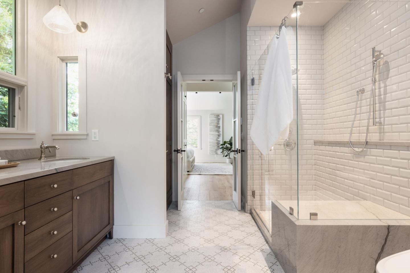 4 Oak Knoll Way Carmel, CA 93923 - Photo 37 of 49 a bathroom with a granite countertop sink a mirror a bathtub and shower