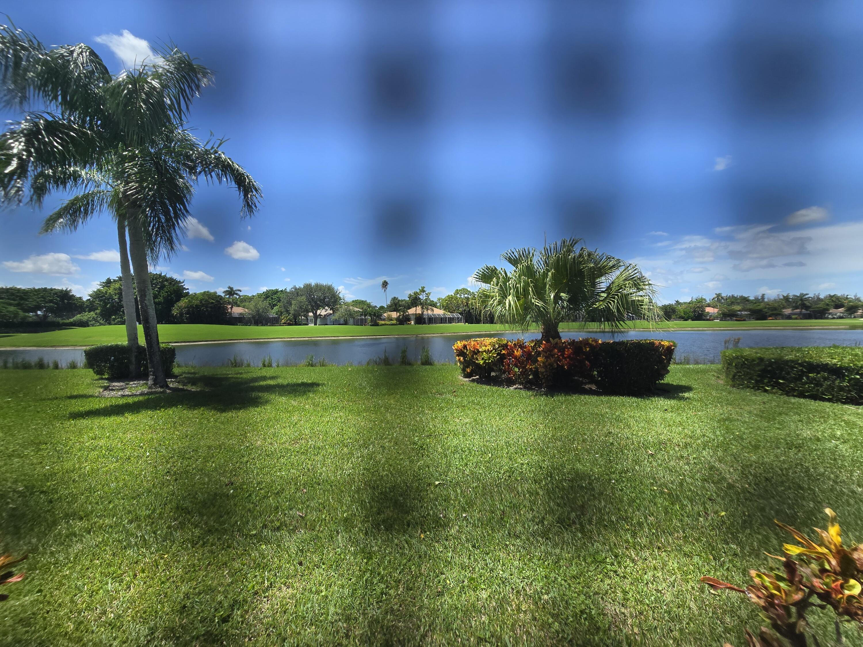 8384 Horseshoe Bay Road Boynton Beach, FL 33472 - Photo 20 of 33 a view of a garden with a building in the background