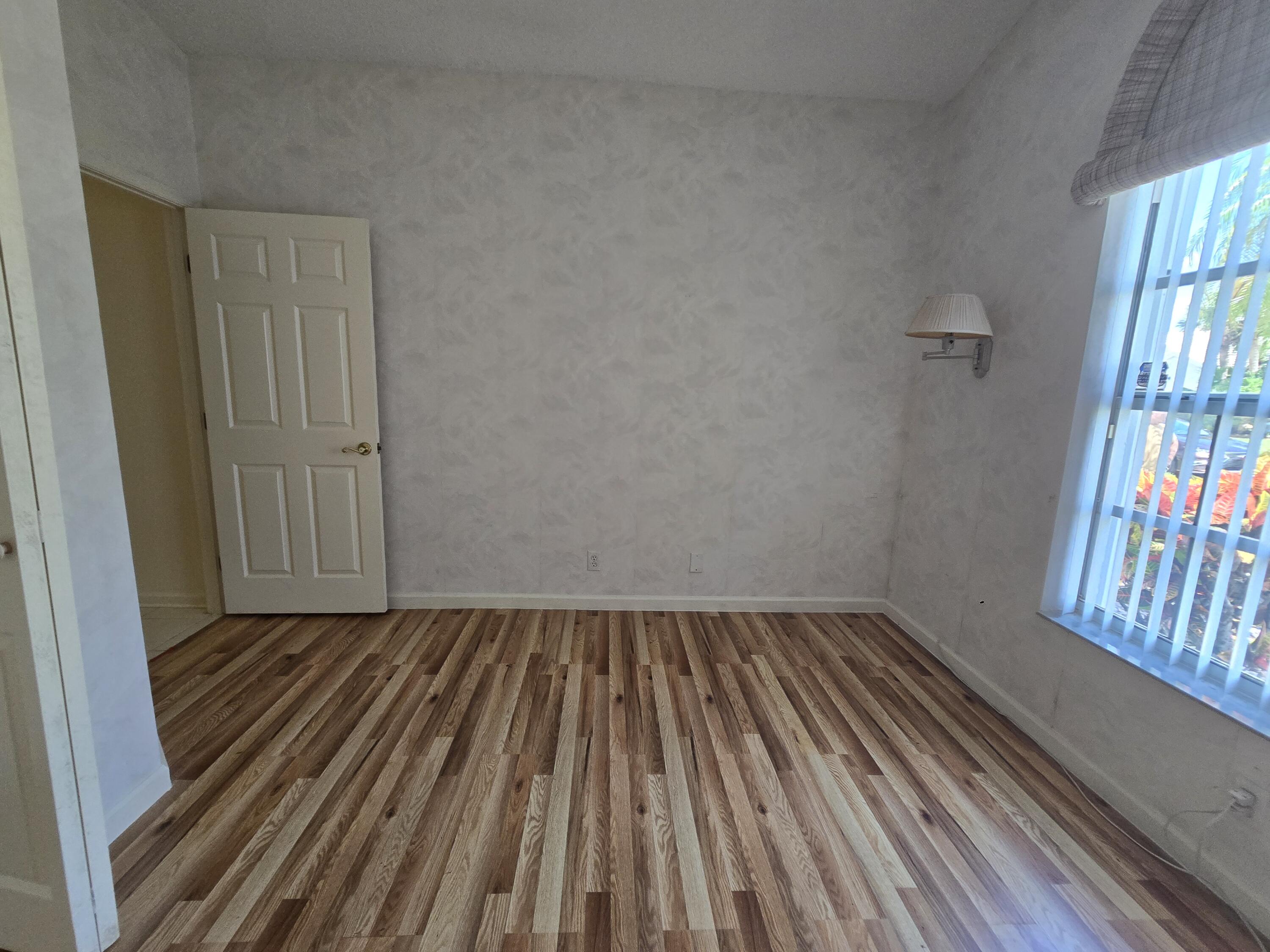 8384 Horseshoe Bay Road Boynton Beach, FL 33472 - Photo 5 of 33 a view of a room with wooden floor and windows