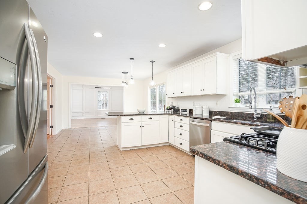 7 Draper Woods Road Sturbridge, MA 01518 - Photo 6 of 38 a kitchen with a sink a stove a refrigerator and cabinets