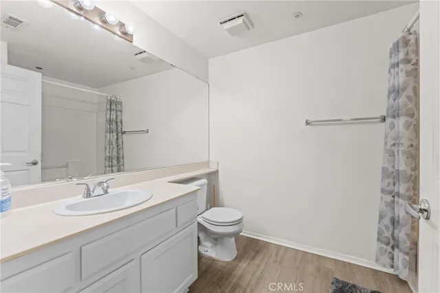 a bathroom with a sink toilet and a mirror