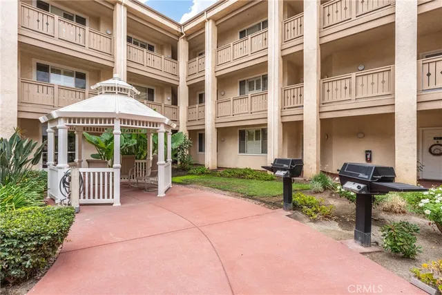 a front view of a house with porch and garden