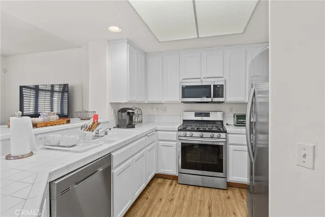 a kitchen with a stove a sink and a microwave