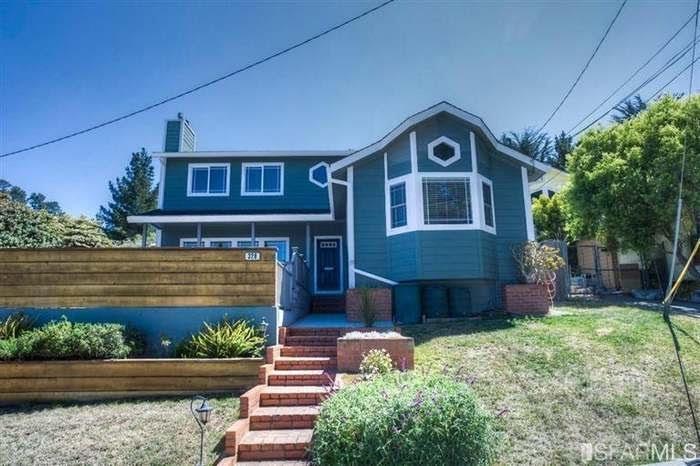 a front view of a house with a yard
