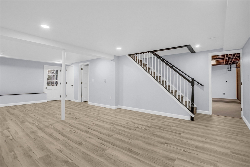 150 Fisher Road Fitchburg, MA 01420 - Photo 12 of 41 a view of an empty room with wooden floor and stairs