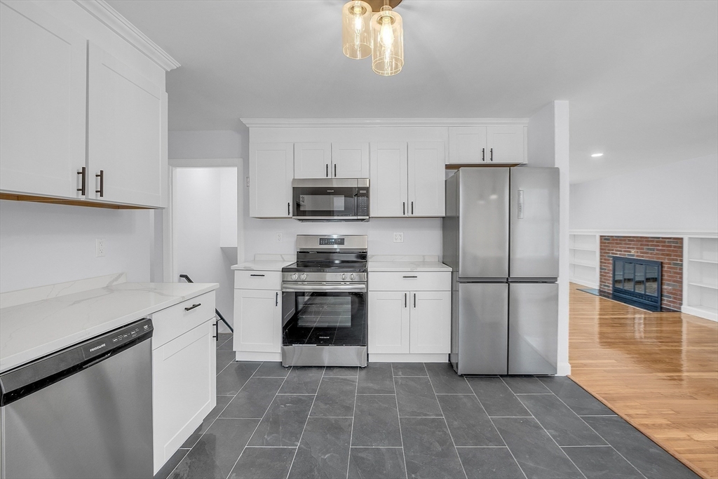 150 Fisher Road Fitchburg, MA 01420 - Photo 17 of 41 a kitchen with a refrigerator a stove a microwave and cabinets