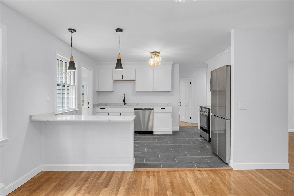 150 Fisher Road Fitchburg, MA 01420 - Photo 4 of 41 a kitchen with kitchen island a sink stainless steel appliances and cabinets
