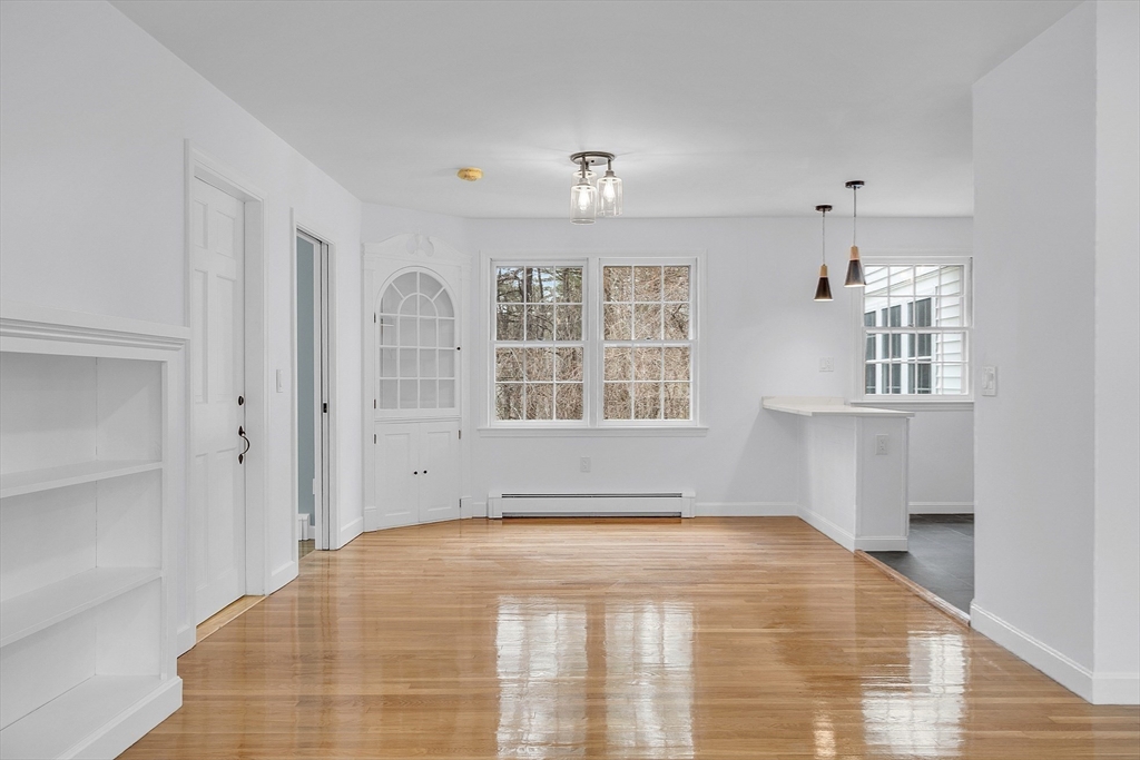 150 Fisher Road Fitchburg, MA 01420 - Photo 6 of 41 a view of empty room with wooden floor and cabinet