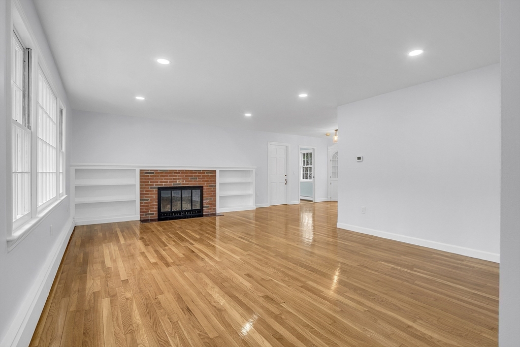 150 Fisher Road Fitchburg, MA 01420 - Photo 8 of 41 a view of an empty room with wooden floor and a window