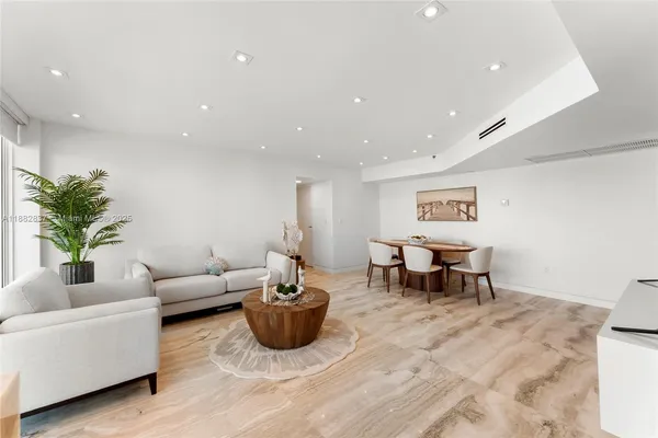 a view of a room with furniture and wooden floor