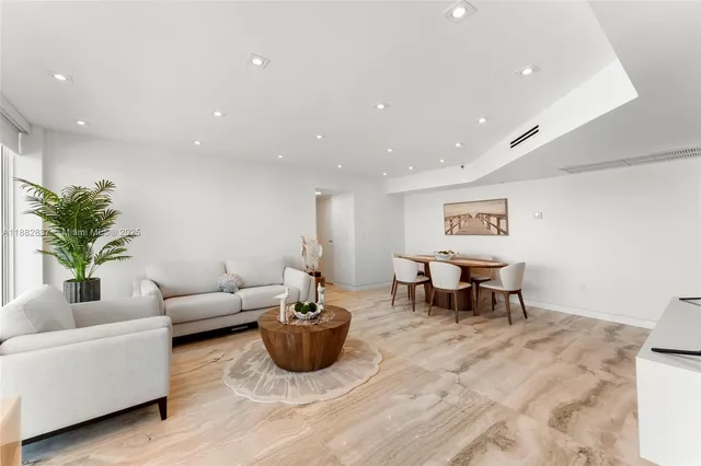 a view of a room with furniture and wooden floor
