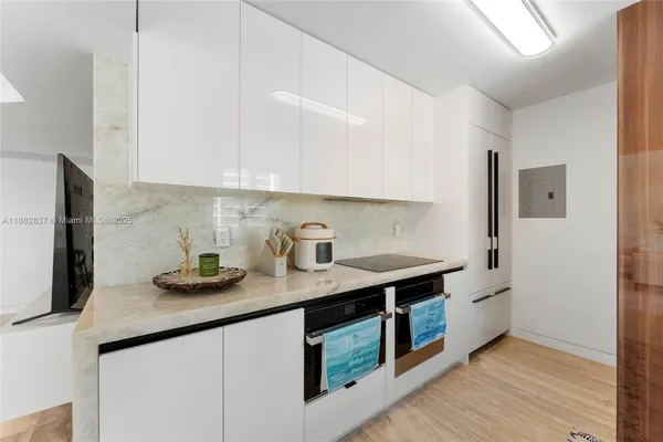 a kitchen with stainless steel appliances granite countertop a sink and a microwave