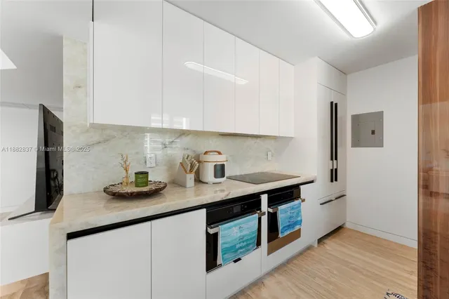 a kitchen with stainless steel appliances granite countertop a sink and a microwave