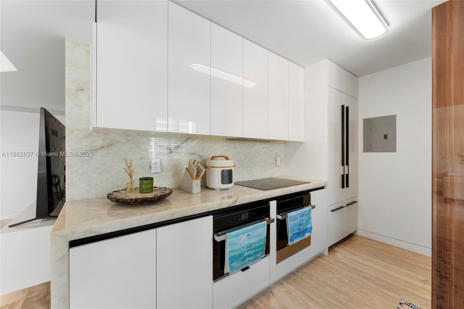 5900 Collins Avenue, Unit 604 Miami Beach, FL 33140 - Photo 17 of 30 a kitchen with stainless steel appliances granite countertop a sink stove and refrigerator