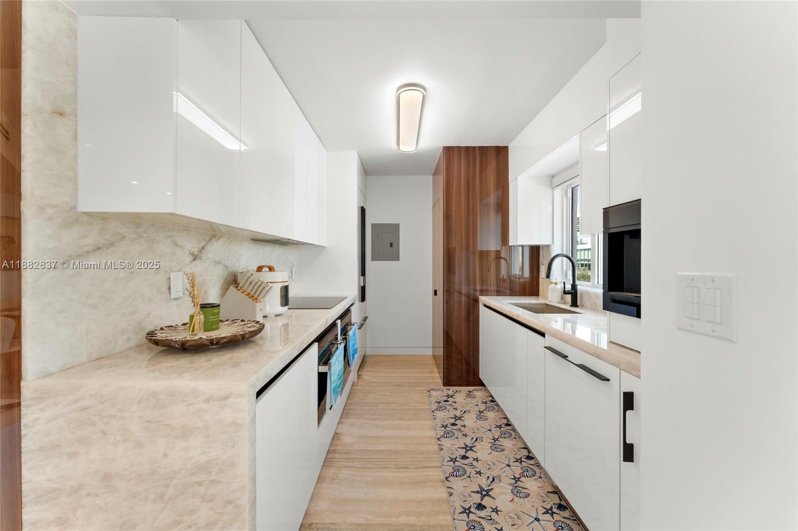 5900 Collins Avenue, Unit 604 Miami Beach, FL 33140 - Photo 19 of 30 a kitchen with stainless steel appliances kitchen island granite countertop a sink and stove