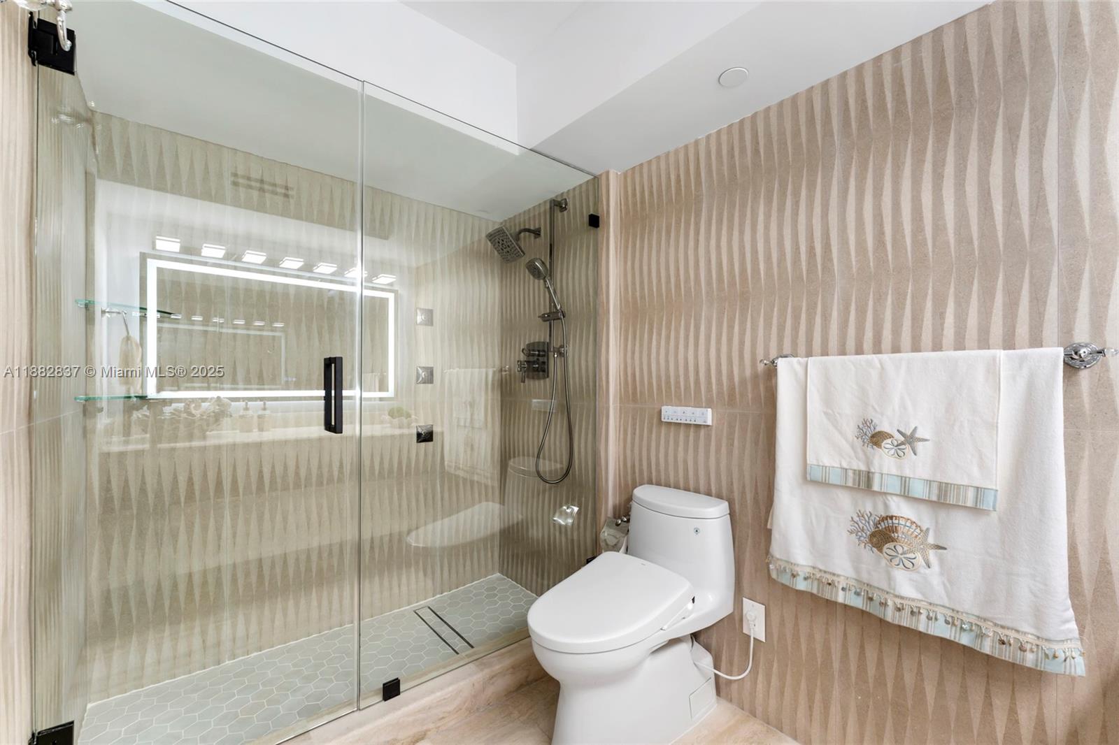 5900 Collins Avenue, Unit 604 Miami Beach, FL 33140 - Photo 24 of 30 a bathroom with a toilet and shower