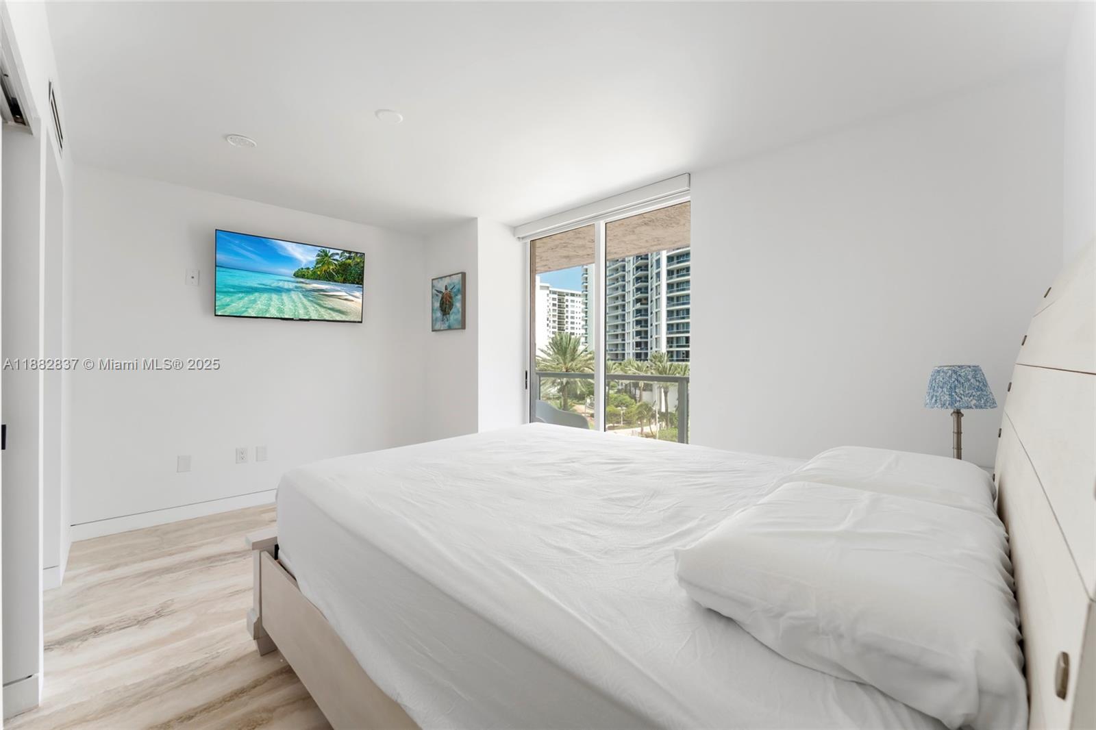5900 Collins Avenue, Unit 604 Miami Beach, FL 33140 - Photo 27 of 30 a bedroom with a bed and a window