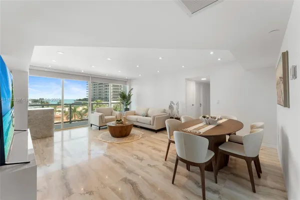 a living room with furniture potted plant and a table