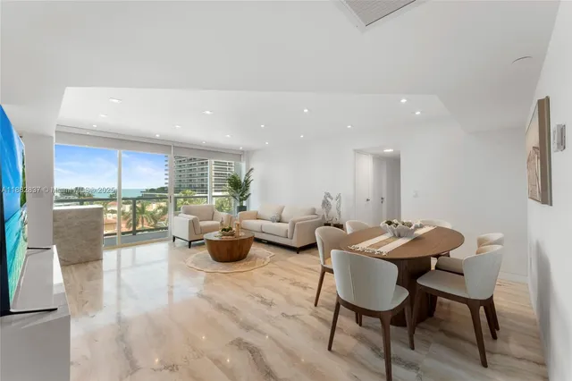 a living room with furniture potted plant and a table