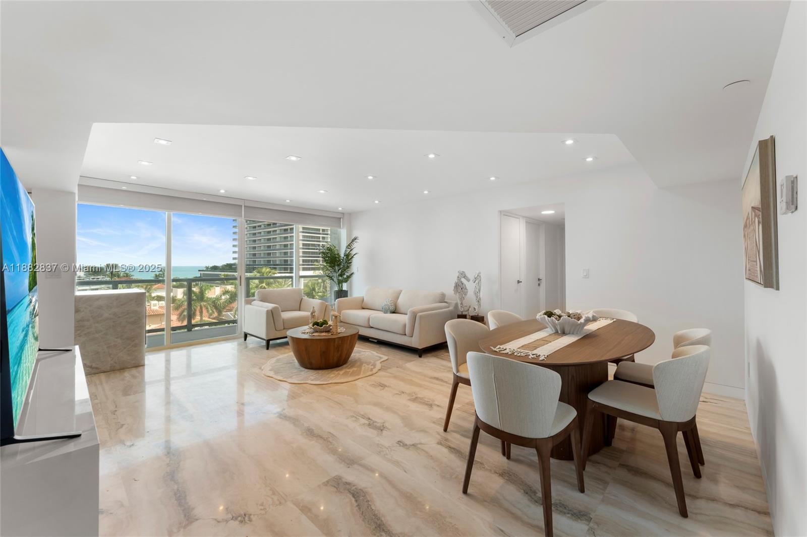 5900 Collins Avenue, Unit 604 Miami Beach, FL 33140 - Photo 10 of 30 a living room with furniture and a large window