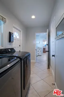 a kitchen that has a sink and a stove in it
