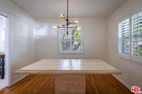 a view of a room that has a bed and a window in it