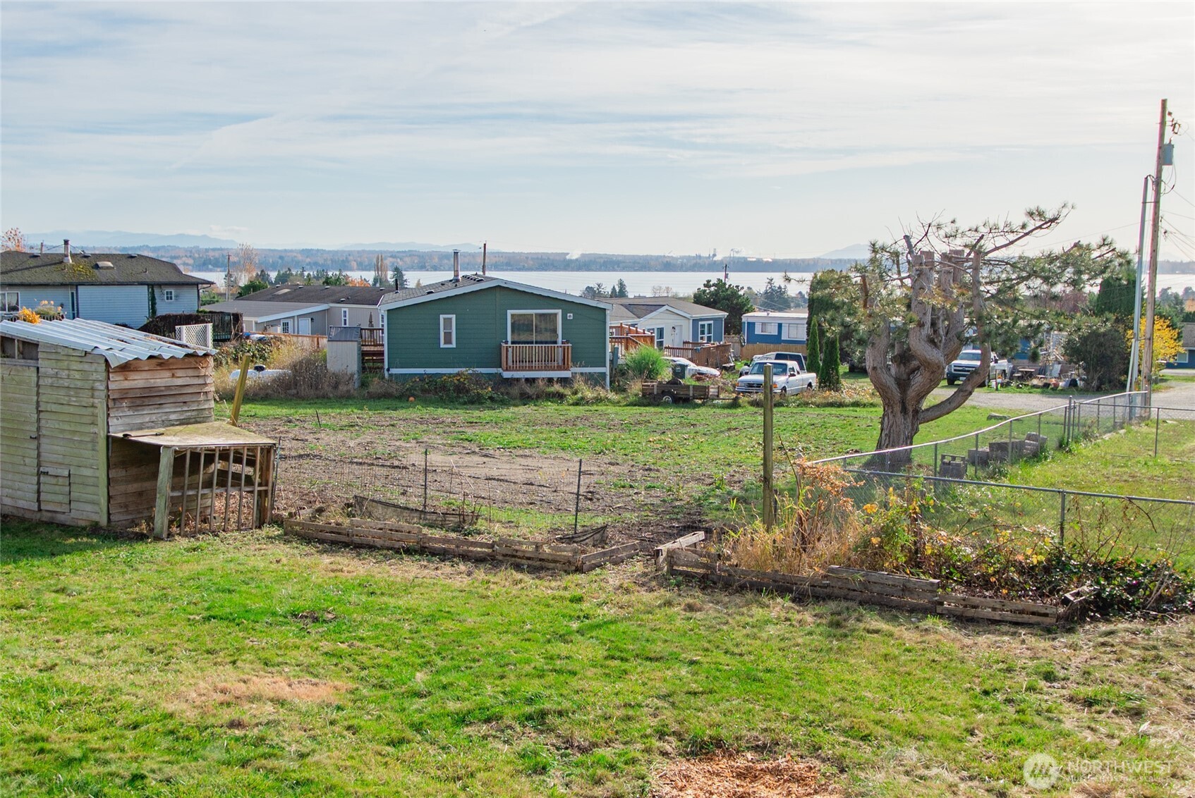 5541 Bayvue Road Blaine, WA 98230 - Photo 14 of 14 a view of a big house with a big yard and large trees