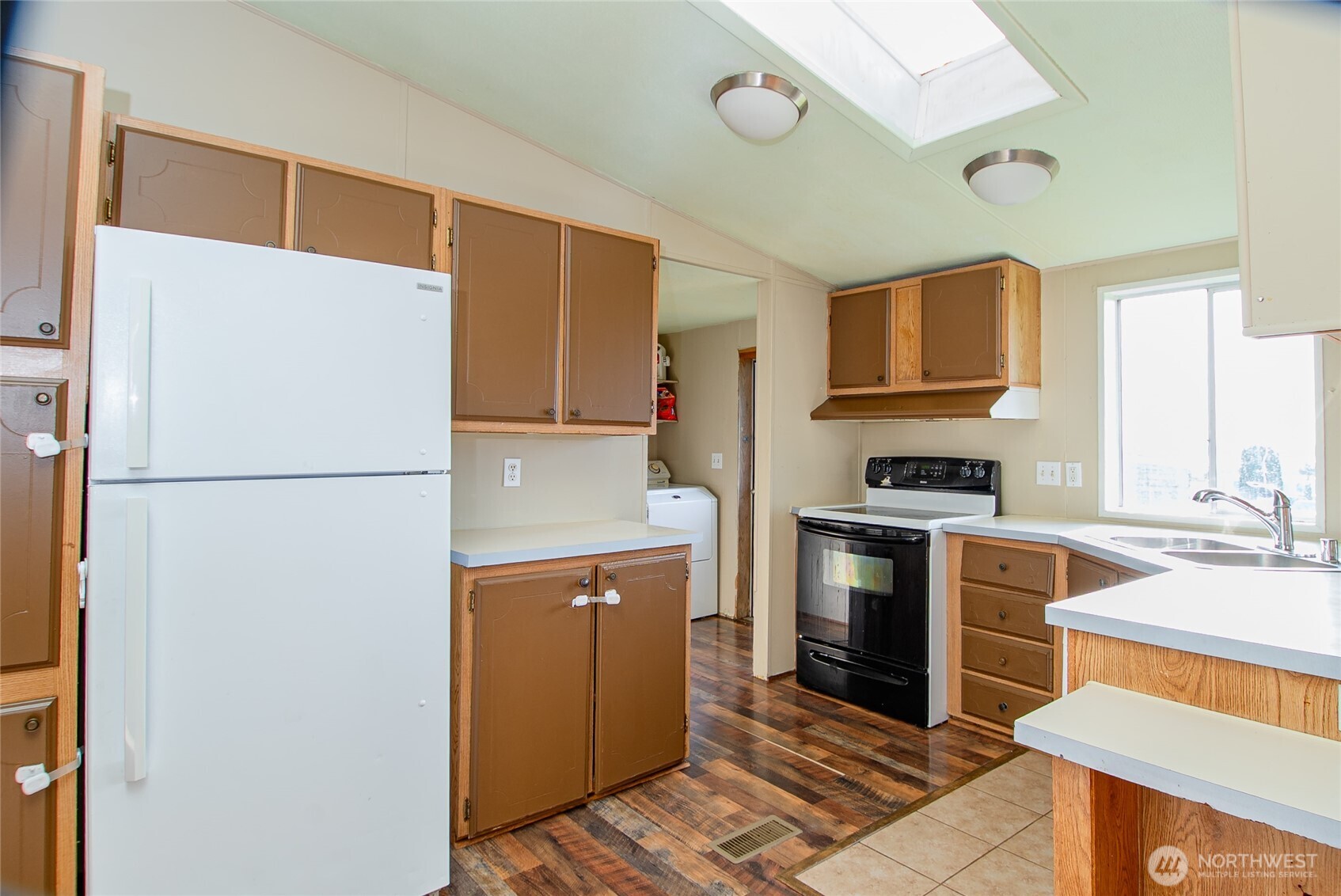 5541 Bayvue Road Blaine, WA 98230 - Photo 3 of 14 a kitchen with a sink a refrigerator and a stove top oven