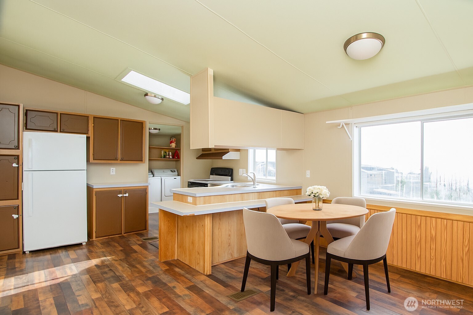 5541 Bayvue Road Blaine, WA 98230 - Photo 5 of 14 a kitchen with a dining table chairs and refrigerator