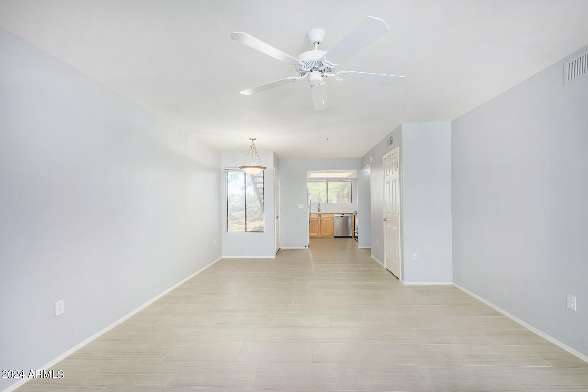 9990 North Scottsdale Road, Unit 1030 Paradise Valley, AZ 85253 - Photo 12 of 40 an empty room with chandelier fan and windows