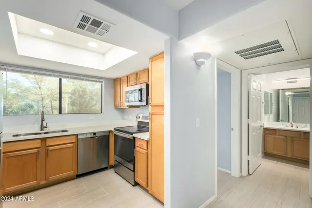 a kitchen with a sink and large window