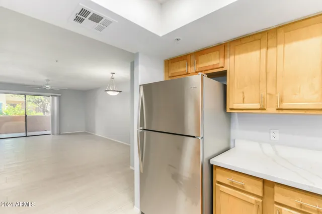 a kitchen with stainless steel appliances granite countertop a refrigerator and a cabinets