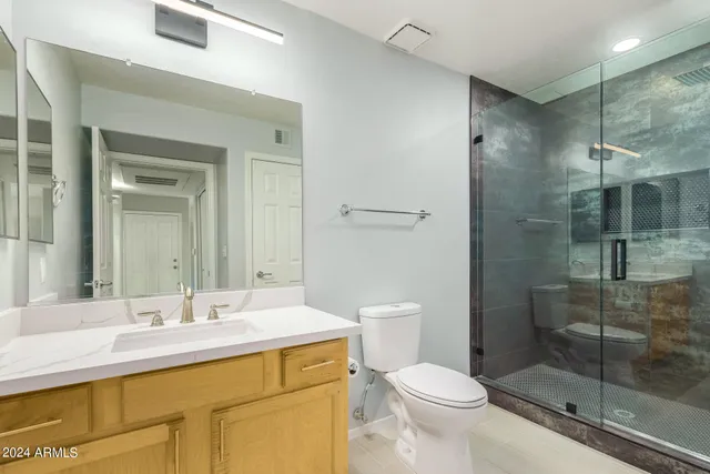 a bathroom with a sink toilet and shower