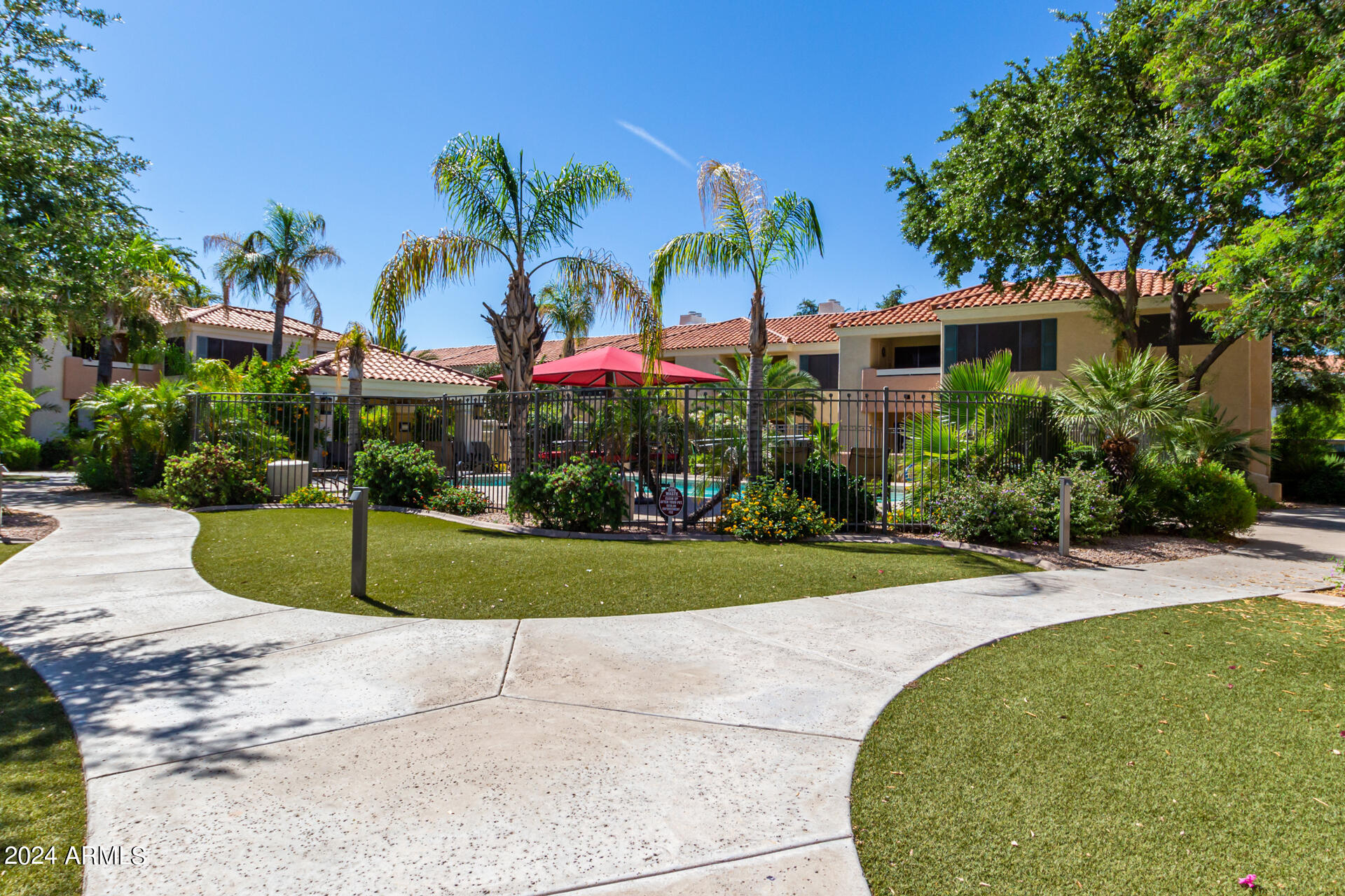 9990 North Scottsdale Road, Unit 1030 Paradise Valley, AZ 85253 - Photo 39 of 40 a front view of a house with a garden and trees