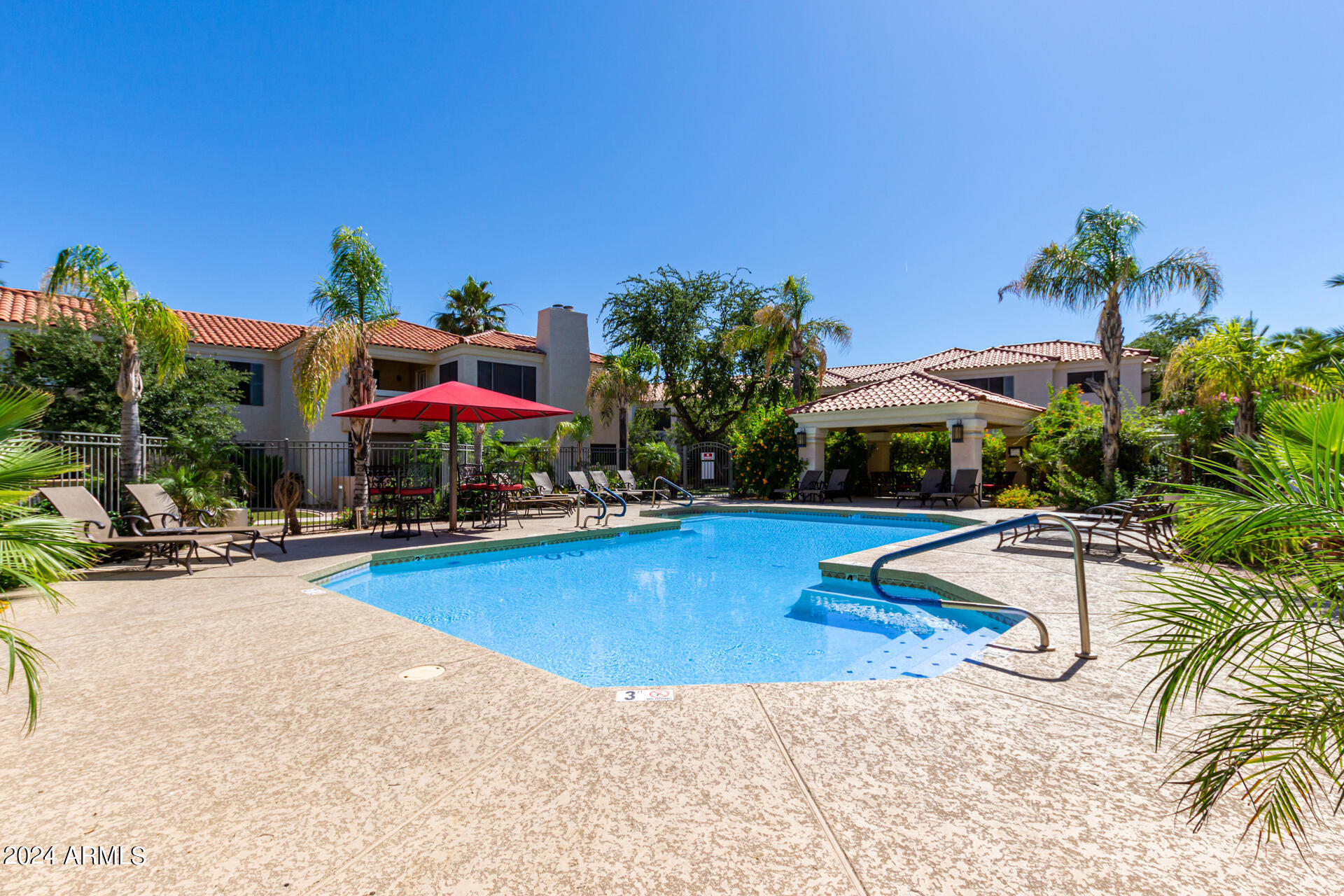 9990 North Scottsdale Road, Unit 1030 Paradise Valley, AZ 85253 - Photo 5 of 40 a view of a swimming pool with lounge chairs