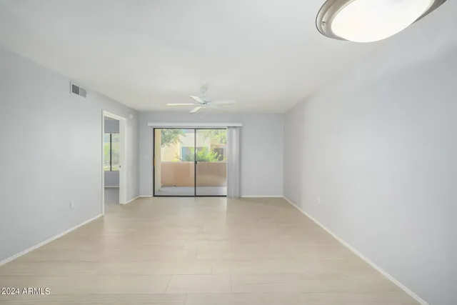 an empty room with windows and closet