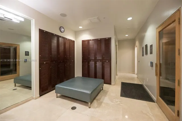 a view of a hallway with a living room and a bathroom