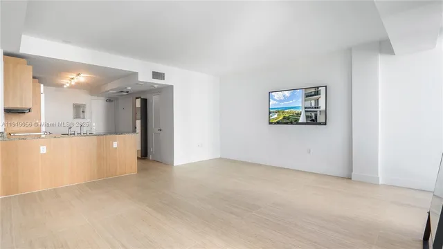 a view of a kitchen with refrigerator and a sink