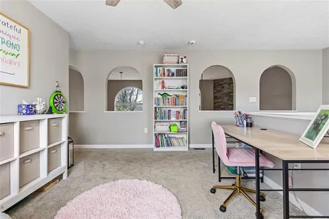 a bathroom with a granite countertop toilet sink and mirror