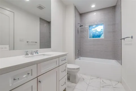 a bathroom with a sink a toilet and bathtub