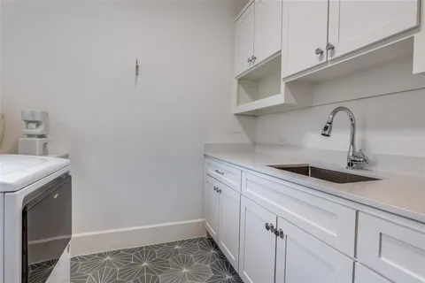a kitchen with a sink and cabinets