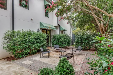 a garden with a bench and some trees
